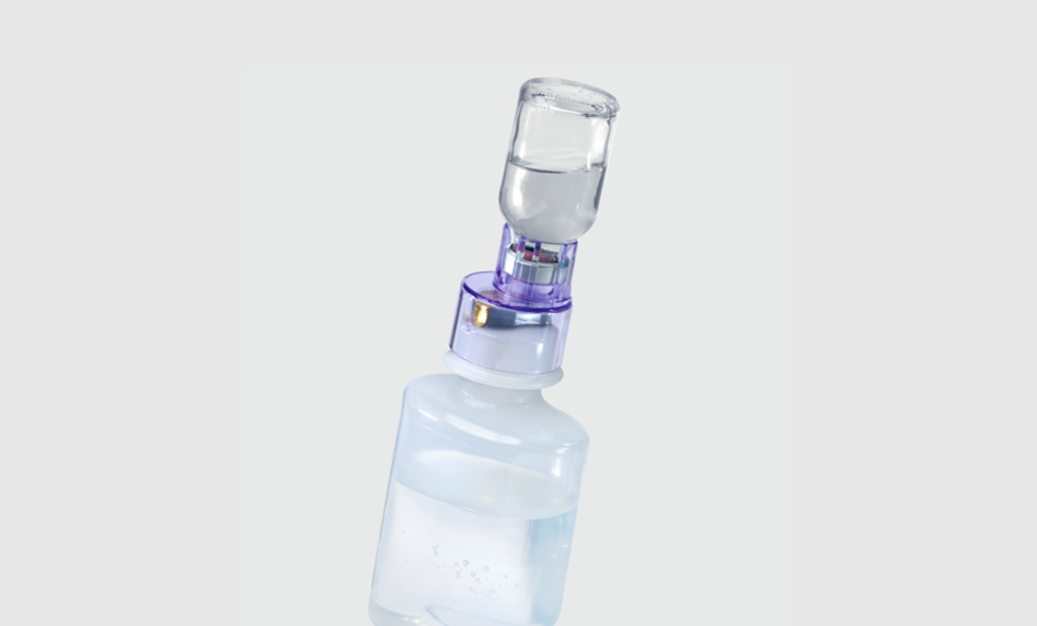 Pharmacist draws up syringe under lamina airflow